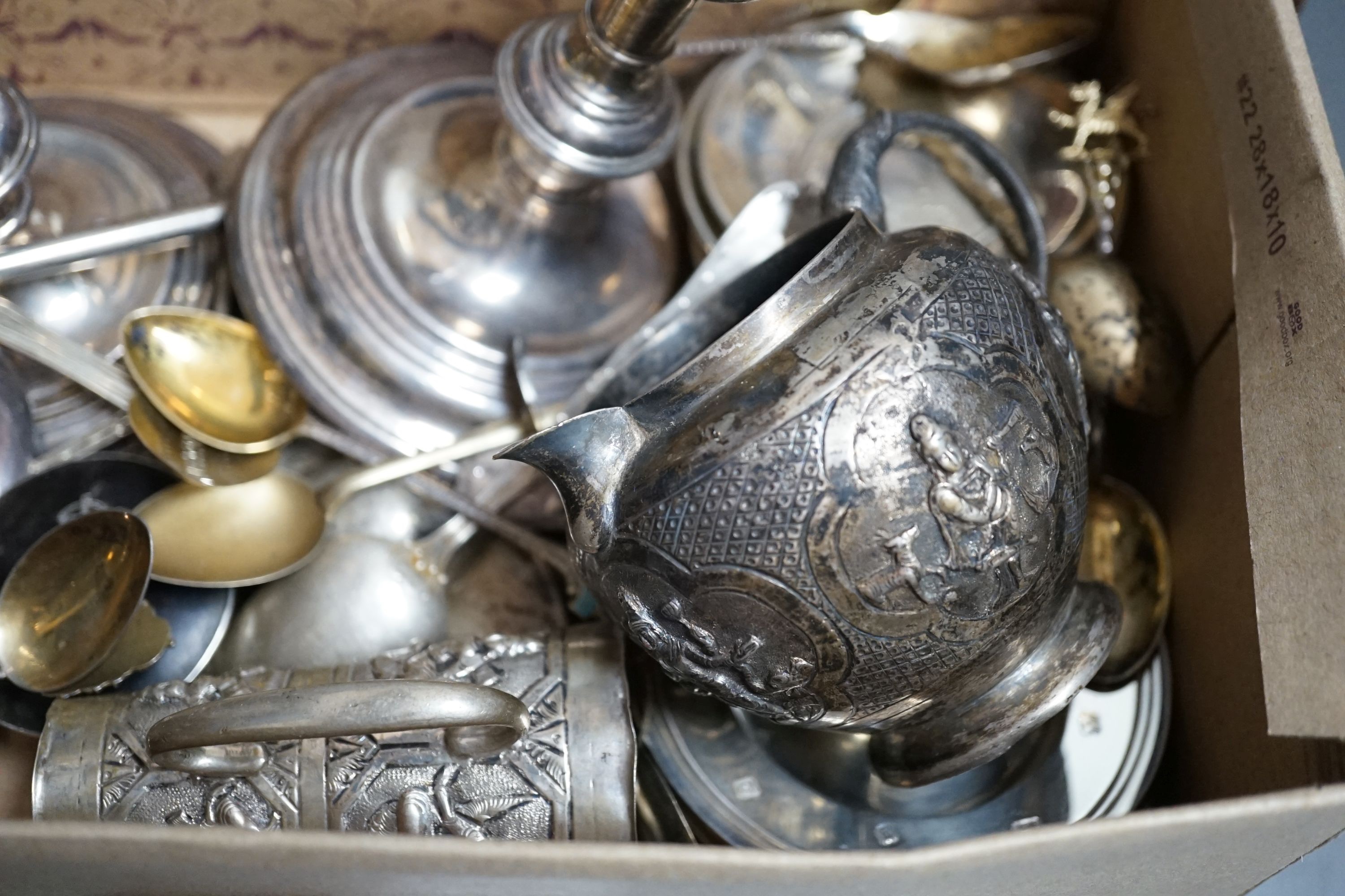 A pair of 1960's silver candlesticks, 19.2cm, weighted, a small silver vase, small silver and tortoiseshell pill box, two small silver armada dishes, two Indian white metal cream jugs, four 'coin' dishes, a quantity of a